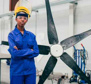 person of color posing with large propeller